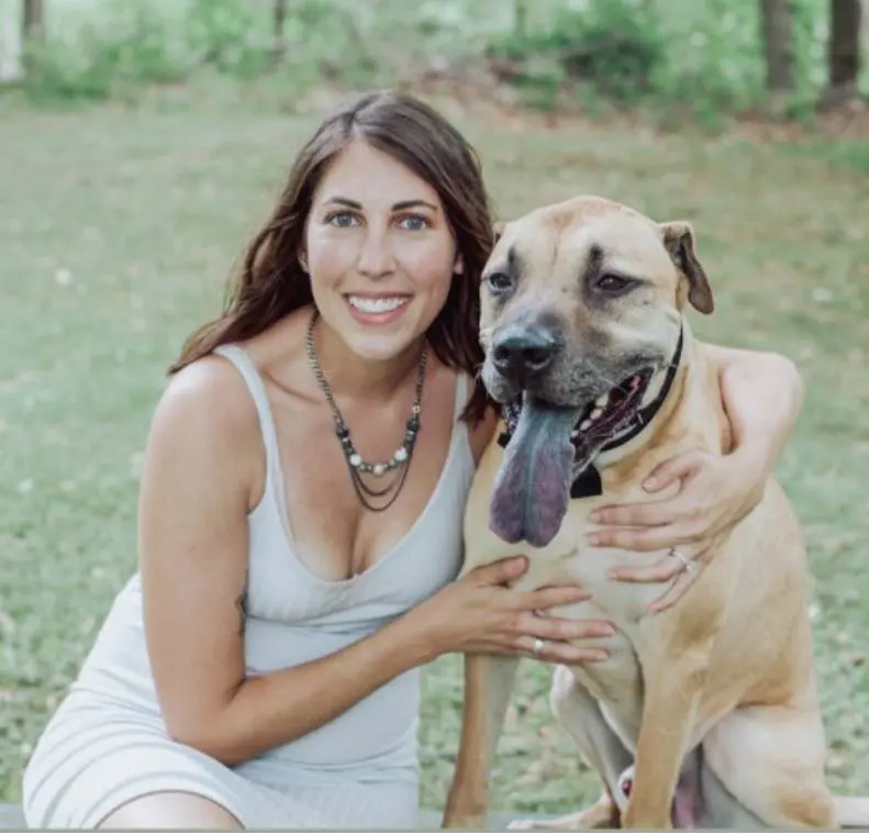 A woman and her dog pose for the camera.